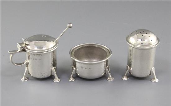 A George V Arts & Crafts silver three piece condiment set,